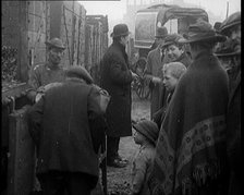 A Group of People Waiting To Receive a Measure of Coal, 1924. Creator: British Pathe Ltd.