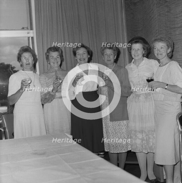 Women with celebratory drinks at the retirement presentation of Mary Coldicott
, 01/08/1986. Creator: John Laing plc.