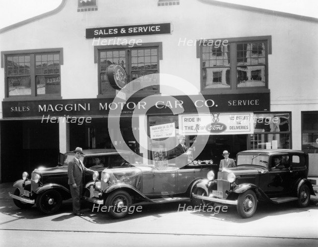 1932 Ford V8 in front of a car showroom, (c1932?). Artist: Unknown