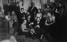 Group portrait of friends at social gathering, seated and standing with tea cups..., c1890 - 1910. Creator: Frances Benjamin Johnston.