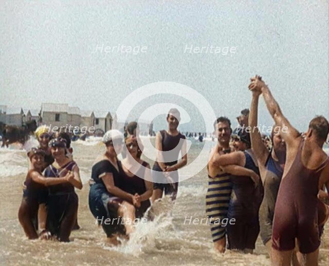 Civilians Wearing Swimsuits Enjoying a Sunny Day Dancing at a Very Crowded Beach, 1920. Creator: British Pathe Ltd.