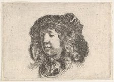 Plate 34: head of a young man in a cap adorned with a few feathers, turned three-quart..., ca. 1646. Creator: Stefano della Bella.