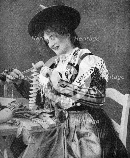 A woman creatively peeling a potato, 1922. Creator: Georg Haeckel.