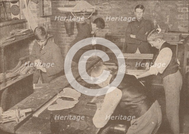 Boys of Harrow School making splints, crutches and other articles for the wounded, c1916 (1928). Artist: Unknown.