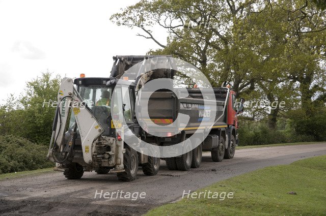 Road resurfacing work repairing potholes Artist: Unknown.