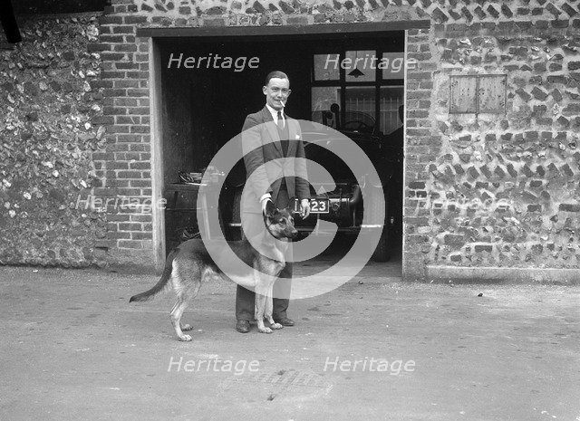 Geoffrey Baker and his alsatian. Artist: Bill Brunell.
