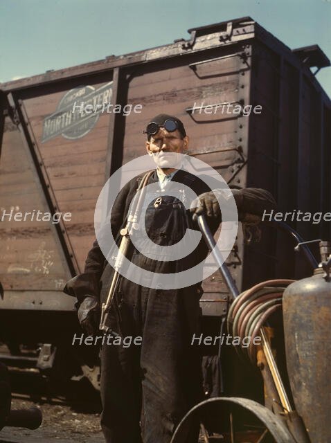 Mike Evans, a welder, at the rip tracks at Proviso yard of the C & NW RR, Chicago, Ill., 1943. Creator: Jack Delano.