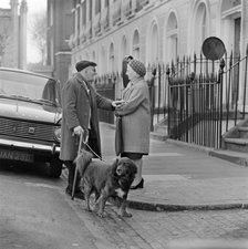 An elderly man chats to an elderly woman on the pavement, London, c1946-c1959. Artist: John Gay