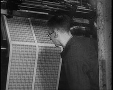 Man Inspecting Stamps Being Printed, 1936. Creator: British Pathe Ltd.