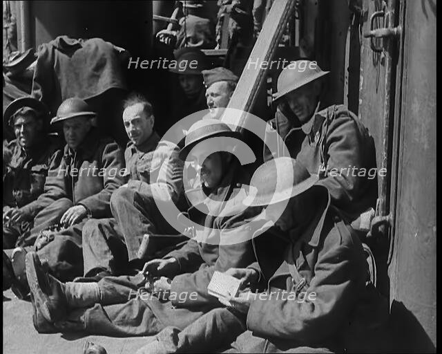 British Soldiers Sitting Aboard a Ship Taking Them Across the Channel Following the..., 1940. Creator: British Pathe Ltd.