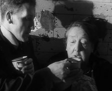 Civilians Drinking Hot Drinks While Sheltering from Bombs in the London Underground, 1940. Creator: British Pathe Ltd.