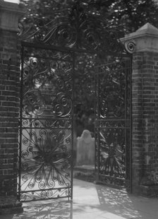 Gates on Broad Street to the graveyard at St. Michael's Episcopal Church, Charleston..., c1920-1926. Creator: Arnold Genthe.