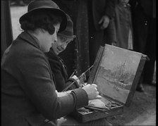 A Woman Artist Sitting at the Side of the Mall Painting the Scene While Watched By Several..., 1937. Creator: British Pathe Ltd.