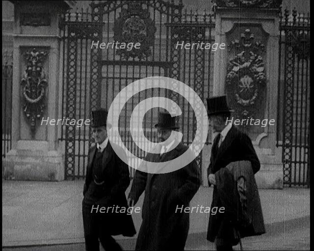 Three British Male Members of Parliament Walking Away from Buckingham Palace, 1924. Creator: British Pathe Ltd.