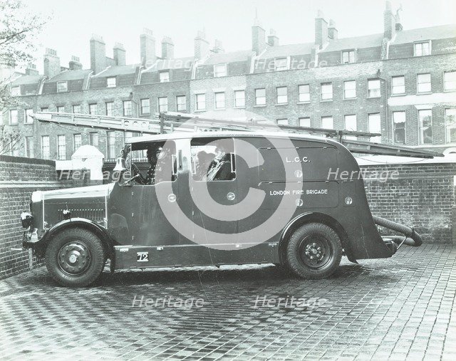 Firemen inside a fire engine, Kingsland Road Fire Station, London, 1935. Artist: Unknown.