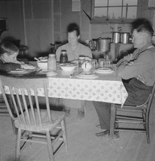 Mr. Wardlow says grace before dinner, Dead Ox Flat, Malheur County, Oregon, 1939. Creator: Dorothea Lange.