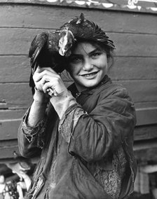 Gipsy girl holding a chicken, 1960s. 
