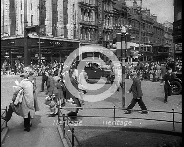 People and Traffic Moving Along Crowded Streets, 1940. Creator: British Pathe Ltd.