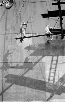 Two men painting a ship in the Royal Albert Dock, Canning Town, London, c1945-c1965. Artist: SW Rawlings