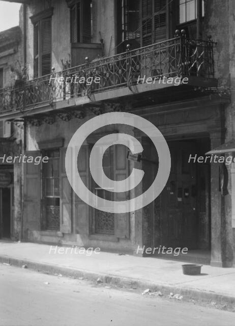 Facades of buildings along a street in the French Quarter, New Orleans, between 1920 and 1926. Creator: Arnold Genthe.