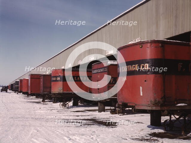 Truck trailers line up at a freight house to load and unload goods...C & NW RR, Chicago, Ill., 1942. Creator: Jack Delano.