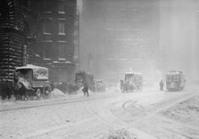 Horse-drawn wagons on snowy street, NY snow storm, 1910. Creator: Bain News Service.