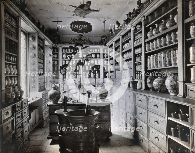 A seventeenth-century German apothecary's shop with ornate pharmacy jars..., c1900s. Creator: Christof Muller.