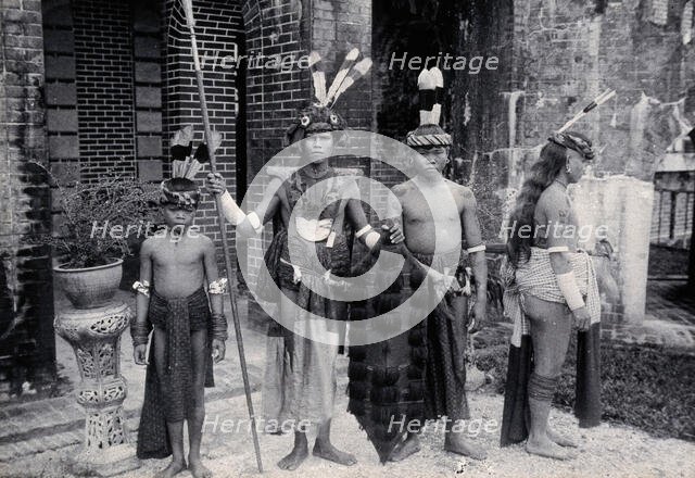 Sarawak: Sea Dayaks with weapons and head-dresses, c1900. Creator: Unknown.