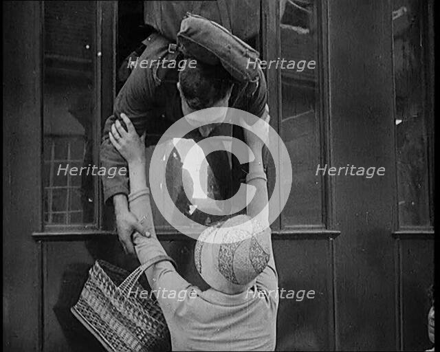 Male Soldier Kissing Female Civilian from the Window of a Train, 1929. Creator: British Pathe Ltd.