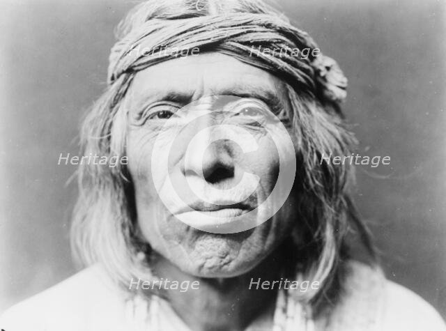 Head-and-shoulders portrait of Shiwawatiwa, a Zuni Indian, facing front, c1903. Creator: Edward Sheriff Curtis.