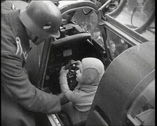 A Young Boy Sitting in the Cockpit of a Fighter Plane, 1930s. Creator: British Pathe Ltd.