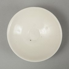 A shallow cream glazed bowl with rolled rim andraised footrim, Tang dynasty, c.800-900. Artist: Unknown.