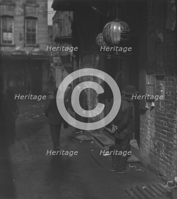 Doorways in dim shadows, Chinatown, San Francisco, between 1896 and 1906. Creator: Arnold Genthe.