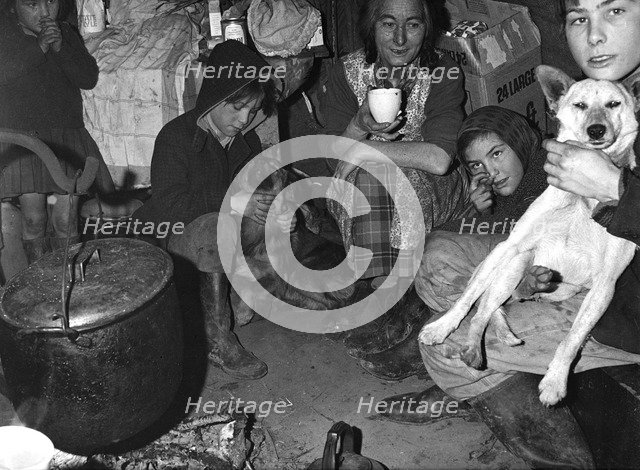 Roadside gipsy family inside a 'bender' (wigwam construction), Newdigate, Surrey, 1960s(?).