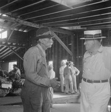 Each farmer follows his tobacco in the warehouse to learn what price..., Douglas, Georgia, 1938. Creator: Dorothea Lange.