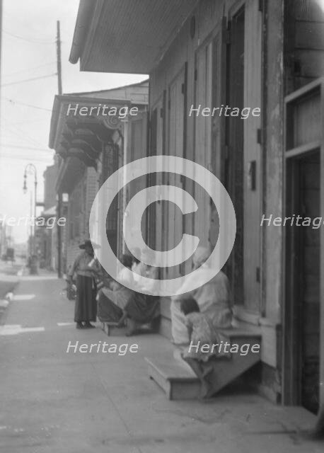 View down a sidewalk, New Orleans, between 1920 and 1926. Creator: Arnold Genthe.