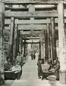 'An Avenue of Torii at Inari', 1910. Creator: Herbert Ponting.