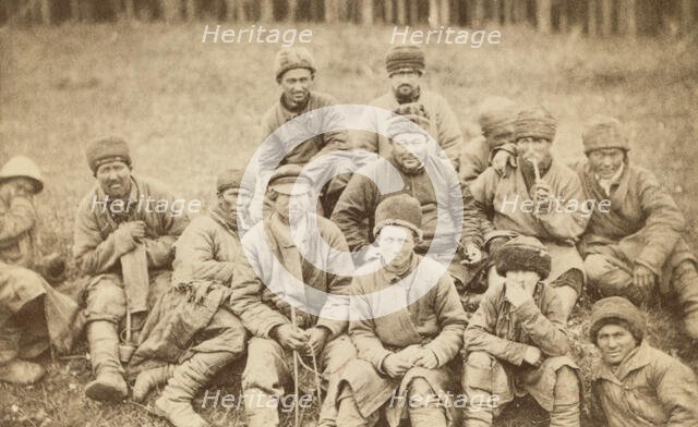 Group portrait of convicts seated in a field, between 1880 and 1886. Creator: Unknown.