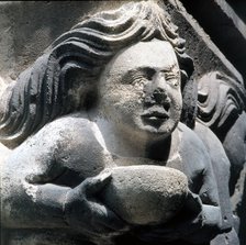 Bust with bowl' capital in the cloister of the Monastery of Ripoll.