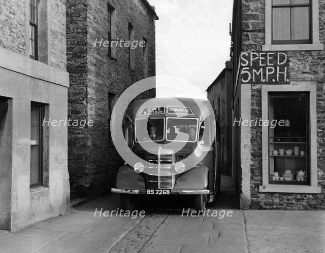 1939-1952 Bedford OB coach in narrow street. Creator: Unknown.