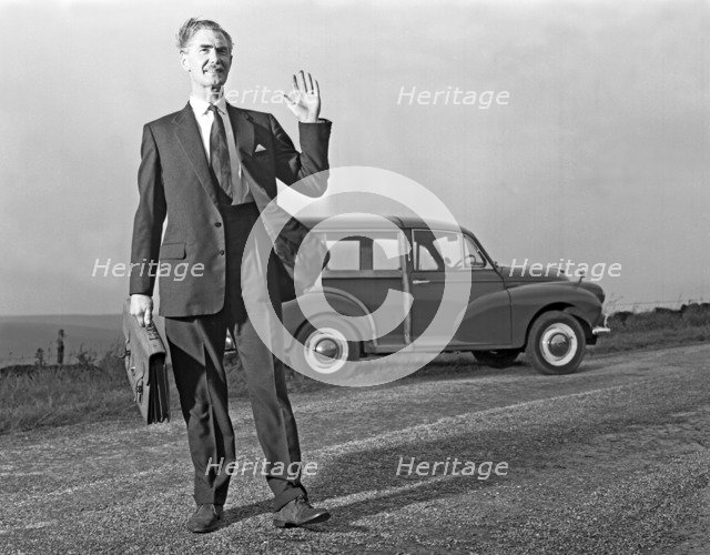 Waving Sales rep with a Moris Minor Shooting Brake, 3rd Aug 1963. Artist: Michael Walters