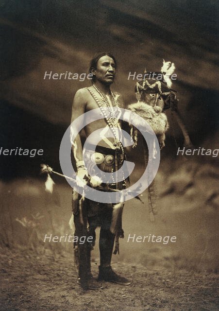 A Navajo man in ceremonial dress representing the Yebichai god Zahabolzi (Zahadolzha?), 1904. Creator: Edward Sheriff Curtis.
