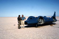 Donald Campbell being interviewed in front of Bluebird CN7, Lake Eyre, Australia, 1964. Creator: Unknown.