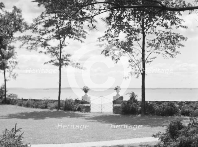 Garden overlooking water, East Hampton, Long Island, between 1933 and 1942. Creator: Arnold Genthe.