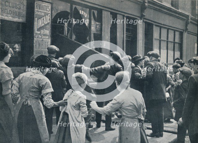 Anti-German rioting in London: A crowd breaking in the windows of a German shop', c1914. Artist: Unknown