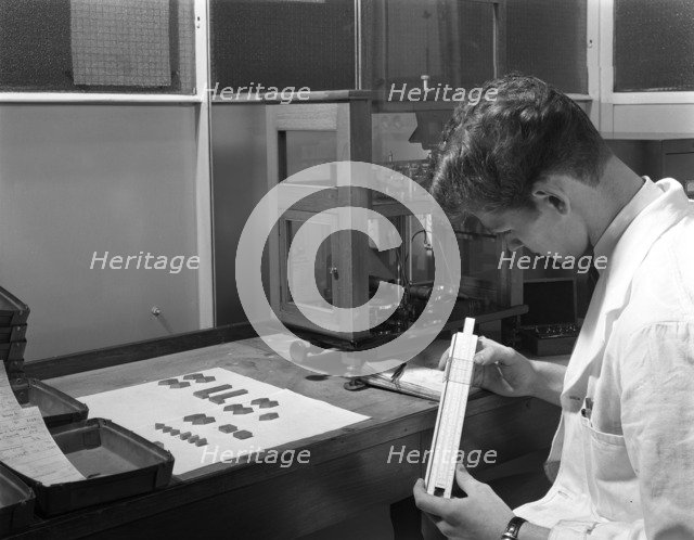 Lab technician with a slide rule, Edgar Allen's steel foundry, Sheffield, South Yorkshire, 1962. Artist: Michael Walters