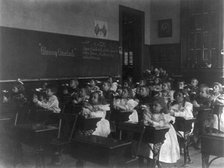 Children in a classroom blowing pinwheels in a Washington, D.C., grade school, (1899?). Creator: Frances Benjamin Johnston.