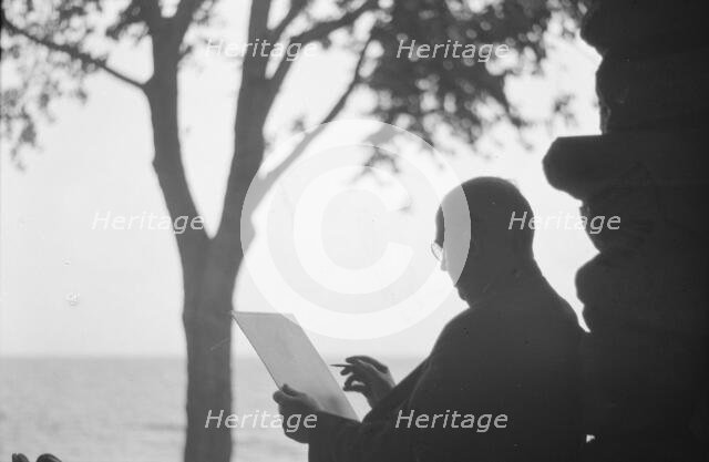 Bruce, Ned, Mr., reading and writing outdoors, 1915? Creator: Arnold Genthe.