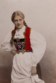 A young Norwegian woman, posing in a photographic studio wearing peasant dress, 1901. Creator: Sostrene Persen.