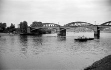 A rowing eight passes under Barnes Bridge, Chiswick, London, c1945-c1965.  Artist: SW Rawlings